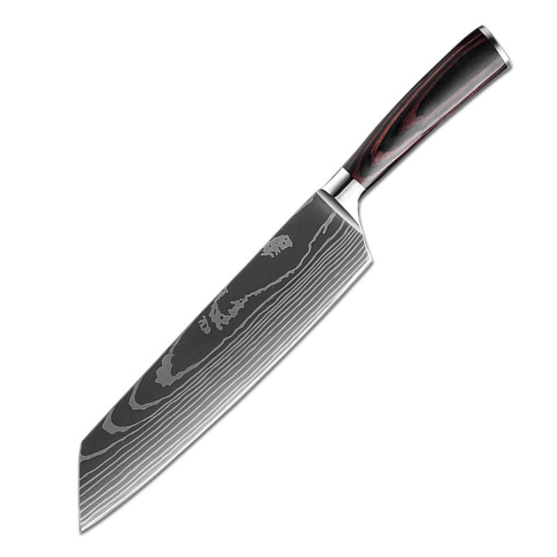 The Domestic Artifact steel kitchen knife set with wood handles, including chef’s knife, paring knife, and utility knife on a wooden cutting board.